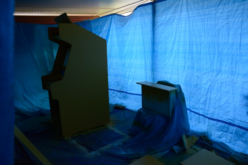 picture of arcade cabinet and parts in painting area
