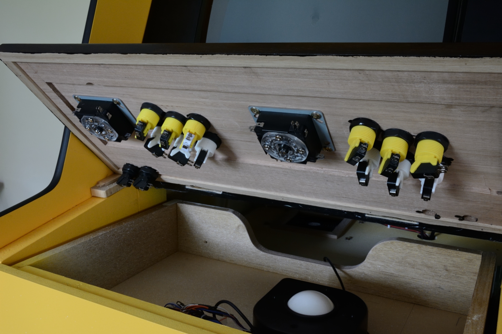 picture of underneath view of control panel with installed joysticks and buttons