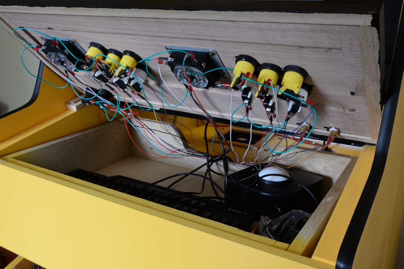 picture of underneath view of control panel with wired up joysticks and buttons