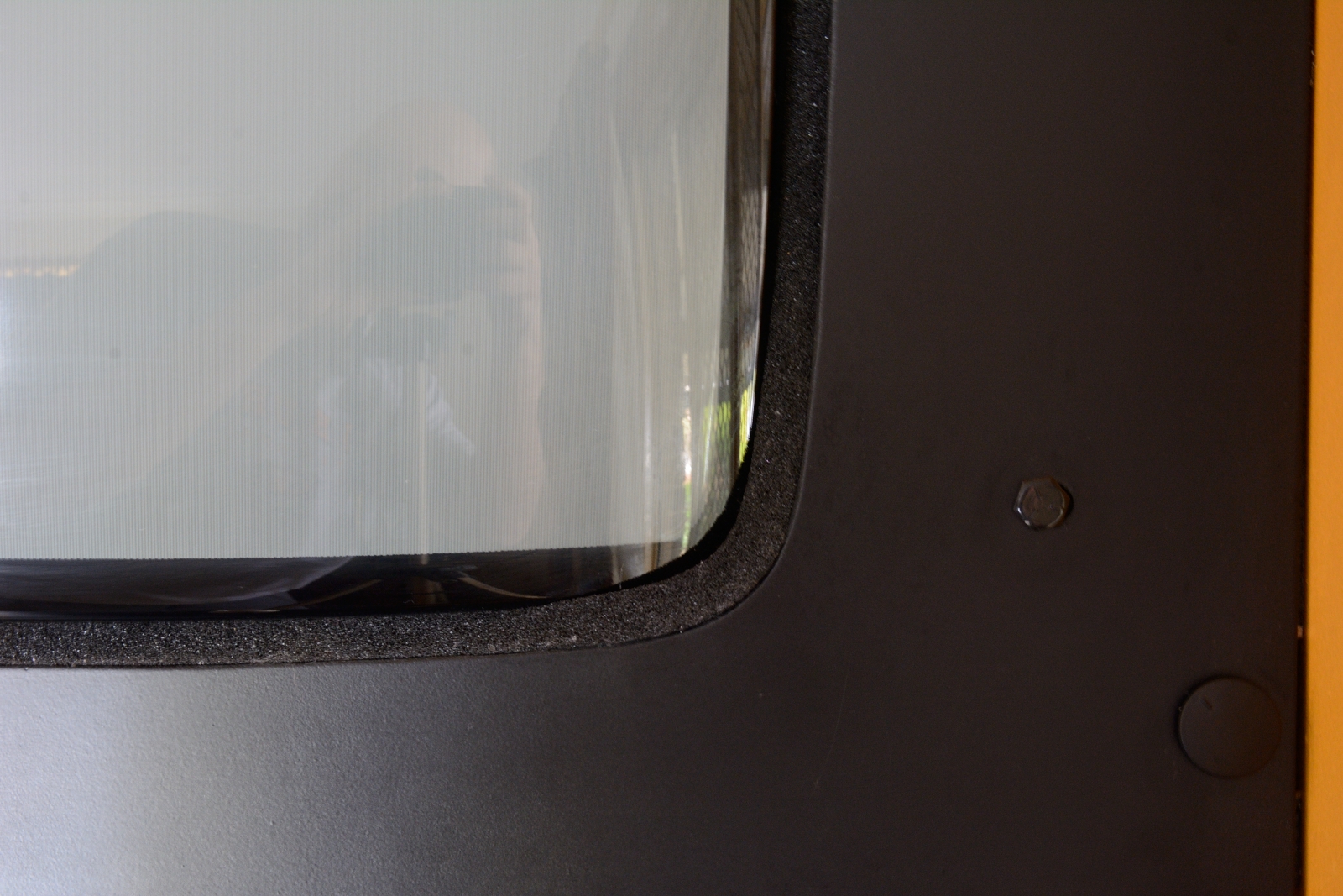 close up picture of foam squeezed between monitor and bezel